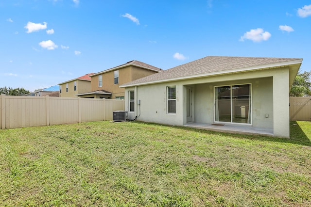 7233 Lumber Port Dr, Ruskin, FL 33573 - back of property featuring stucco siding, a fenced backyard, a shingled roof, and a patio area