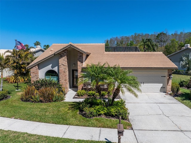 view of front of home with stucco siding, a front lawn, concrete driveway, an attached garage, and a tiled roof