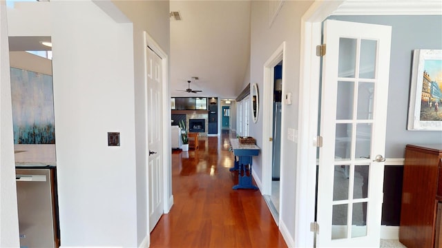 hall with visible vents and wood finished floors