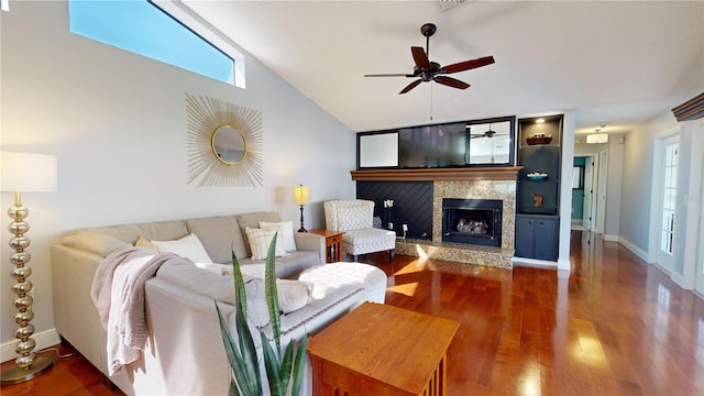 living room with plenty of natural light, a fireplace, ceiling fan, and wood finished floors