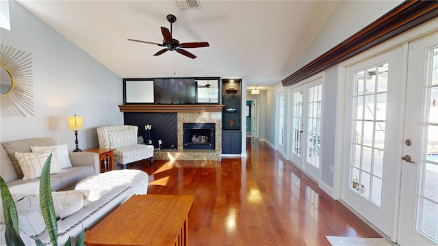 living area with wood finished floors, visible vents, ceiling fan, vaulted ceiling, and french doors