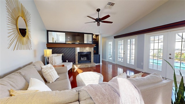 living room featuring a ceiling fan, wood finished floors, visible vents, lofted ceiling, and french doors