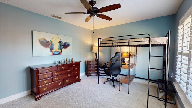 carpeted bedroom featuring visible vents, baseboards, and ceiling fan