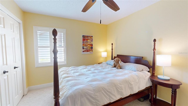 bedroom featuring a closet, ceiling fan, baseboards, and carpet floors