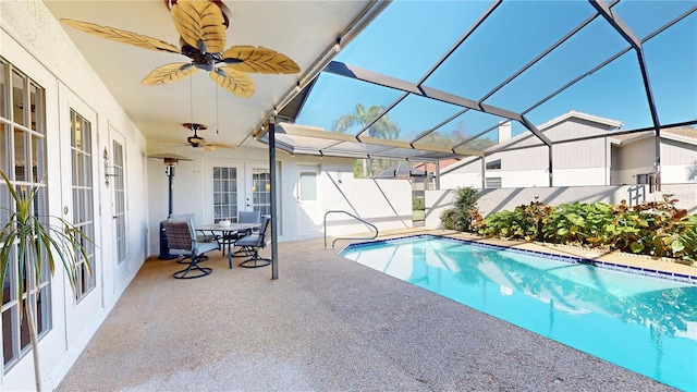 view of swimming pool featuring a fenced in pool, ceiling fan, a lanai, french doors, and a patio