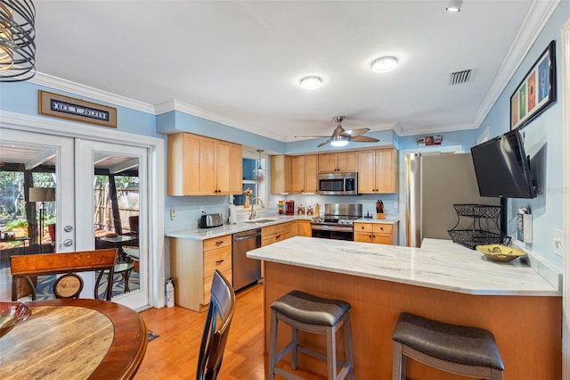 kitchen featuring visible vents, light brown cabinets, french doors, appliances with stainless steel finishes, and a peninsula