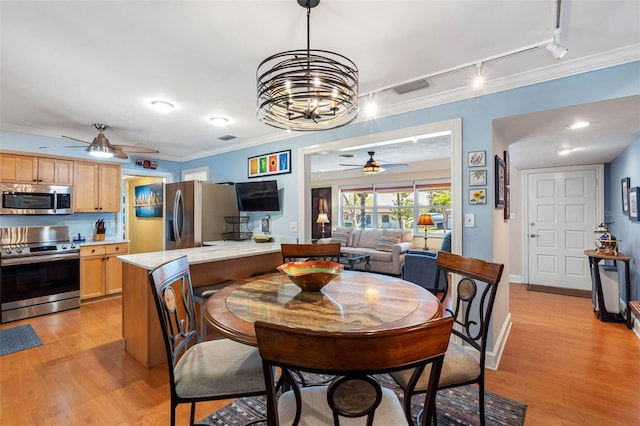 dining area featuring visible vents, track lighting, crown molding, baseboards, and light wood-style floors