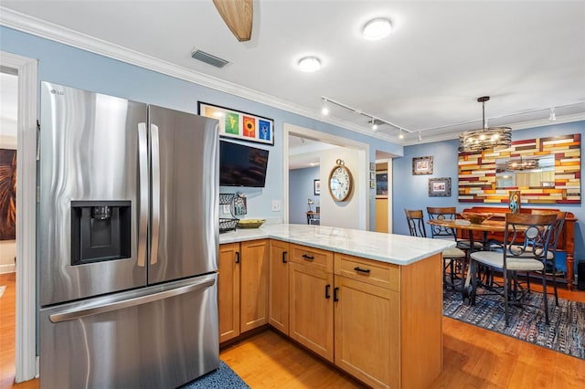 kitchen featuring visible vents, crown molding, and stainless steel fridge with ice dispenser