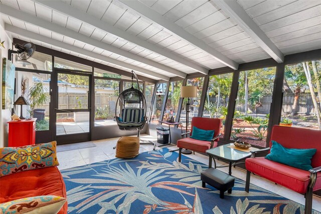 sunroom / solarium with a wealth of natural light, lofted ceiling with beams, and wooden ceiling