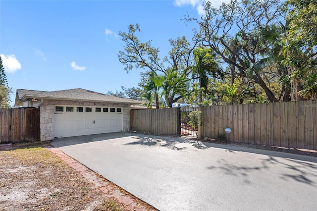 garage with a gate and fence