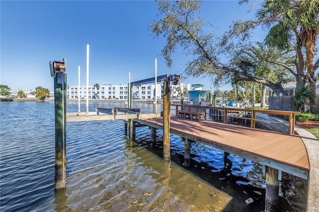 dock area featuring boat lift and a water view