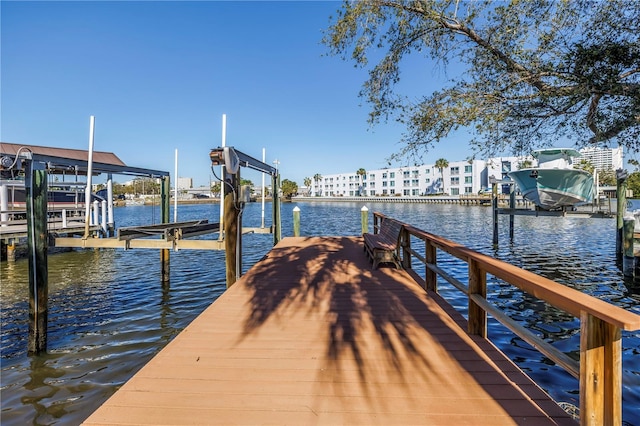 dock area featuring boat lift and a water view