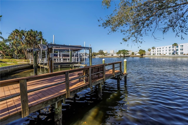 dock area featuring boat lift and a water view