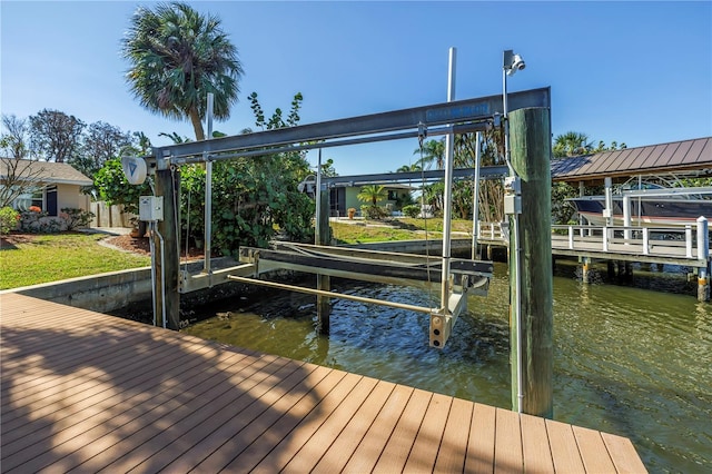 dock area with boat lift and a water view