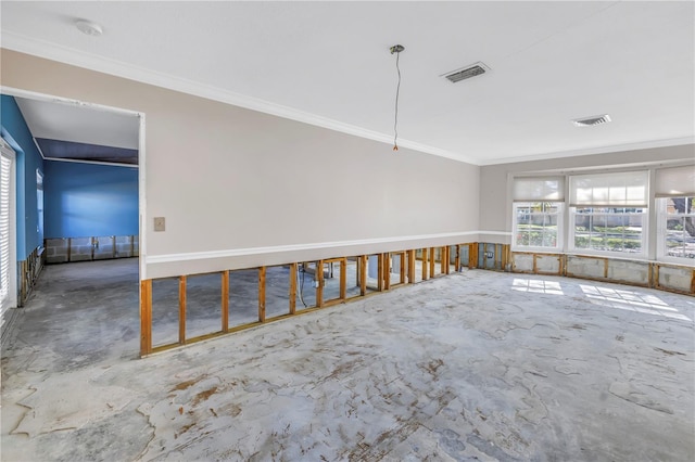 unfurnished room featuring unfinished concrete flooring, visible vents, and ornamental molding