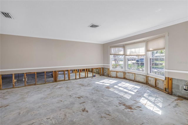 unfurnished room featuring visible vents, unfinished concrete floors, and crown molding