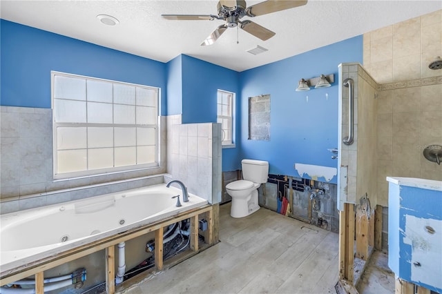 full bath featuring visible vents, toilet, a stall shower, wood finished floors, and a tub with jets