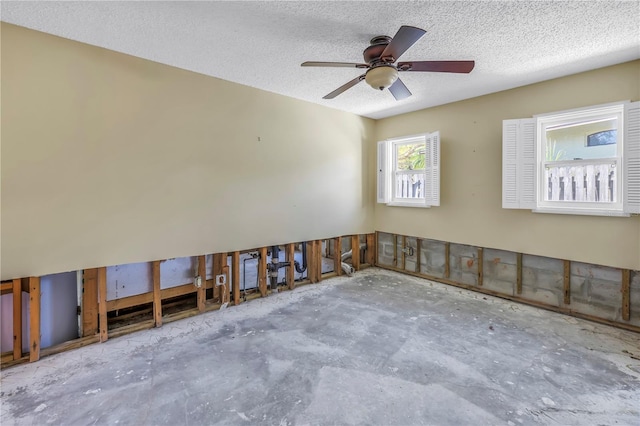 spare room with a textured ceiling and ceiling fan