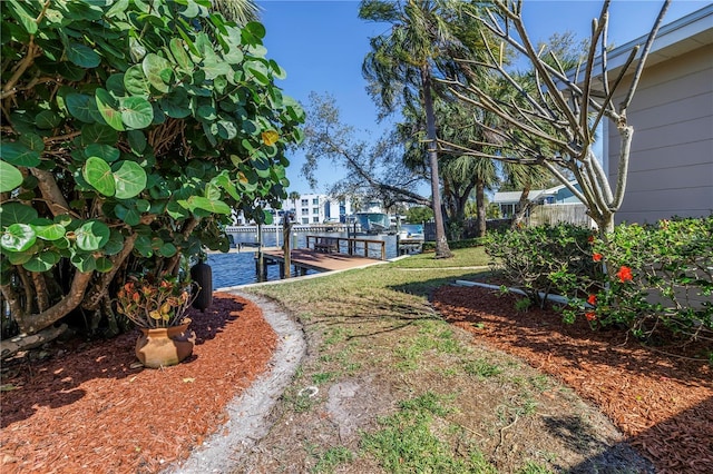 view of yard featuring a dock and fence