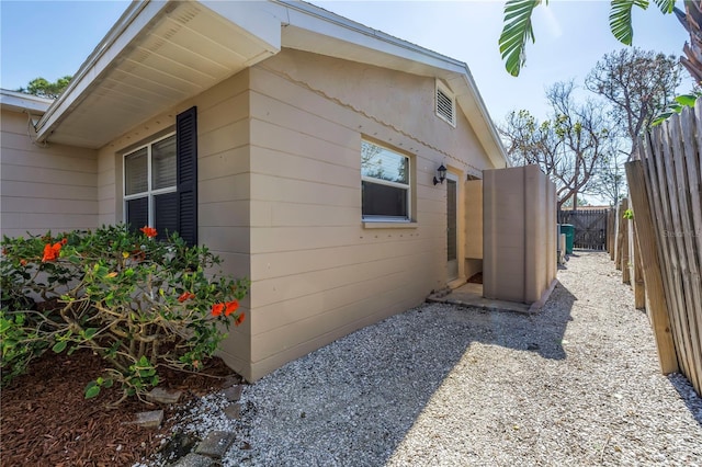 view of home's exterior featuring fence