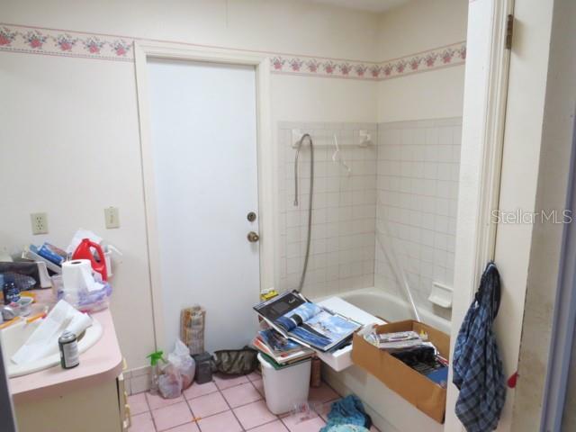 full bath featuring tile patterned floors and  shower combination