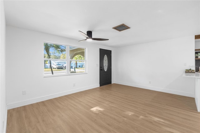 unfurnished living room with baseboards, light wood-style floors, and ceiling fan