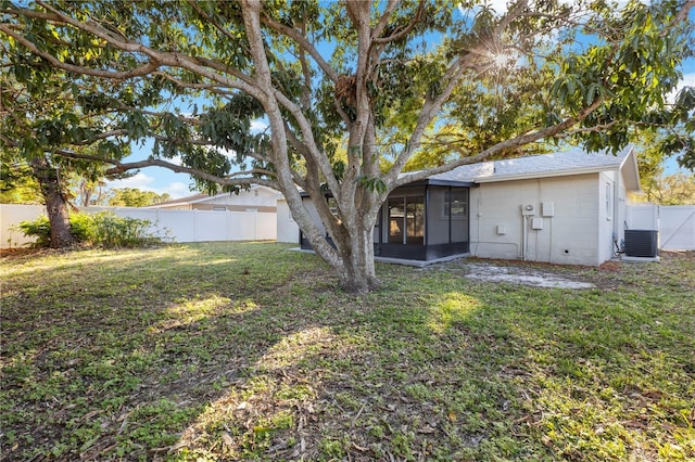 view of yard with a fenced backyard and a sunroom