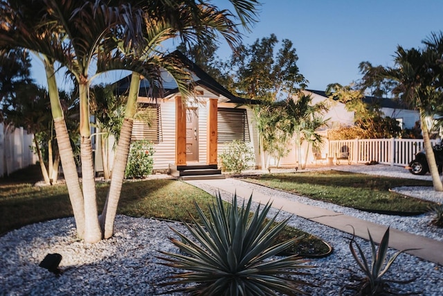 view of front of property with a front lawn and fence