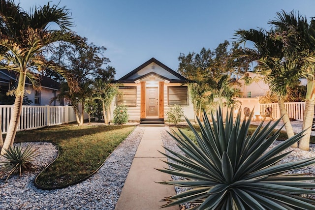 view of front facade with a front yard and fence