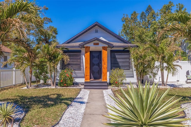 view of front of home featuring a front yard and fence