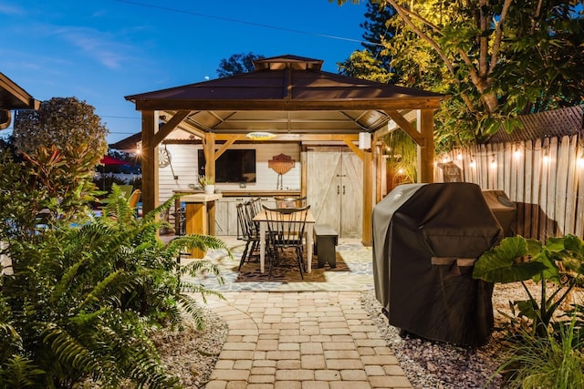 view of patio featuring a gazebo, grilling area, and fence