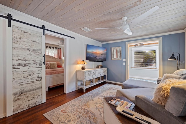 living area with a barn door, plenty of natural light, wooden ceiling, and a ceiling fan