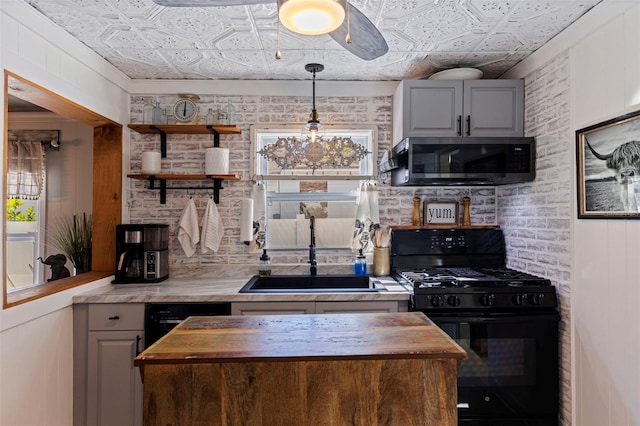 kitchen featuring an ornate ceiling, black appliances, wood counters, and a sink