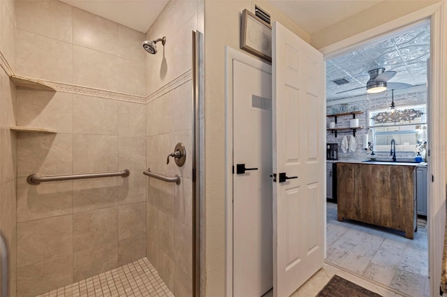 bathroom with vanity, visible vents, a stall shower, and ceiling fan