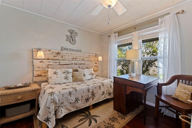 bedroom featuring wood finished floors, a ceiling fan, and ornamental molding