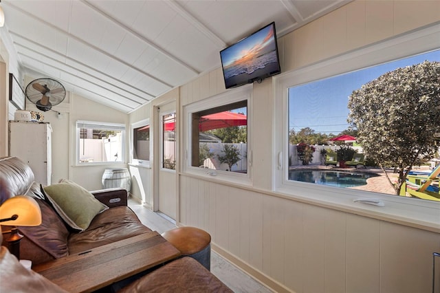 sunroom featuring lofted ceiling with beams