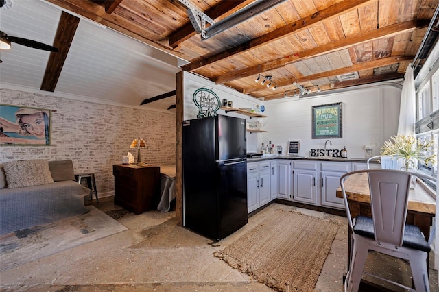 kitchen with dark countertops, beam ceiling, freestanding refrigerator, a ceiling fan, and open shelves