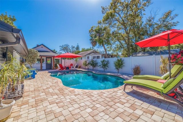 view of swimming pool with a patio, a fenced backyard, and a fenced in pool