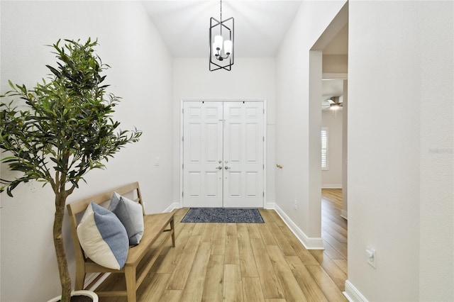 8766 Shadyside Ln, Land O Lakes, FL 34637 - entrance foyer with light wood-style flooring, a chandelier, and baseboards