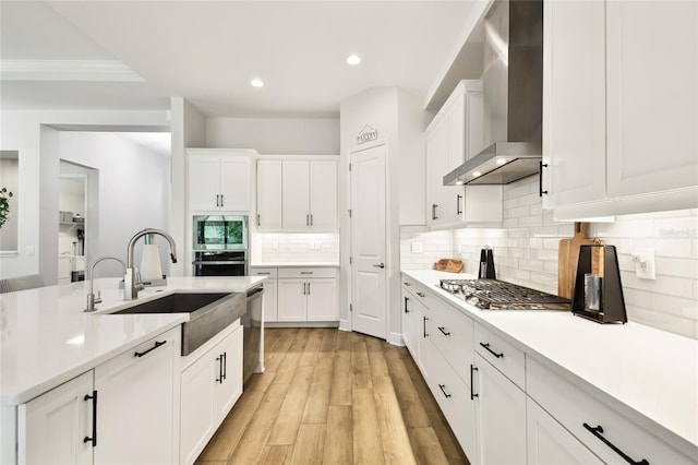 8766 Shadyside Ln, Land O Lakes, FL 34637 - kitchen with wall chimney exhaust hood, a sink, light countertops, recessed lighting, and tasteful backsplash