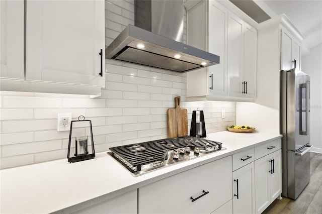 8766 Shadyside Ln, Land O Lakes, FL 34637 - kitchen with wall chimney exhaust hood, appliances with stainless steel finishes, light countertops, and white cabinets