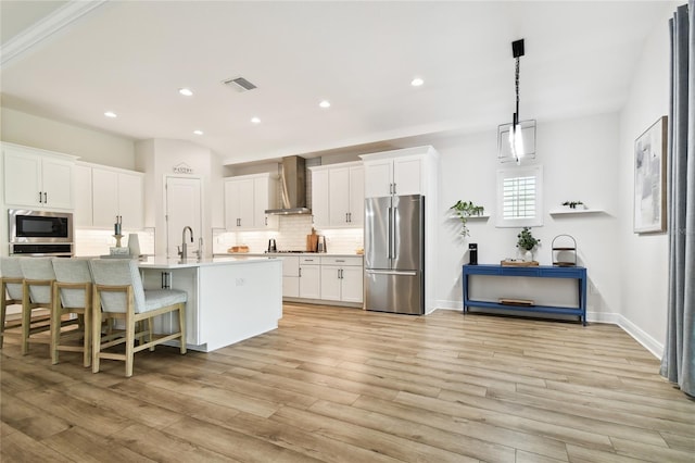 8766 Shadyside Ln, Land O Lakes, FL 34637 - kitchen featuring appliances with stainless steel finishes, wall chimney range hood, backsplash, white cabinets, and light countertops