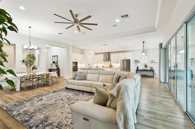 8766 Shadyside Ln, Land O Lakes, FL 34637 - living room with ceiling fan, light wood-style floors, crown molding, a chandelier, and recessed lighting