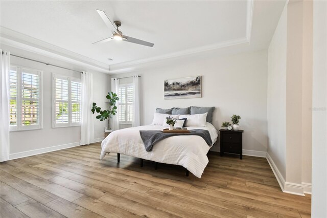 8766 Shadyside Ln, Land O Lakes, FL 34637 - bedroom featuring a tray ceiling, light wood finished floors, baseboards, and a ceiling fan