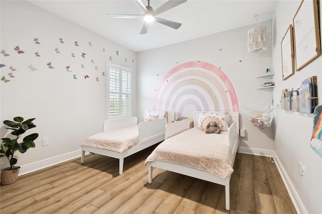 8766 Shadyside Ln, Land O Lakes, FL 34637 - bedroom with wood finished floors, baseboards, and a ceiling fan