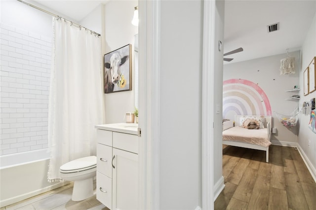 8766 Shadyside Ln, Land O Lakes, FL 34637 - ensuite bathroom featuring vanity, shower / bath combination with curtain, toilet, wood finished floors, and a ceiling fan