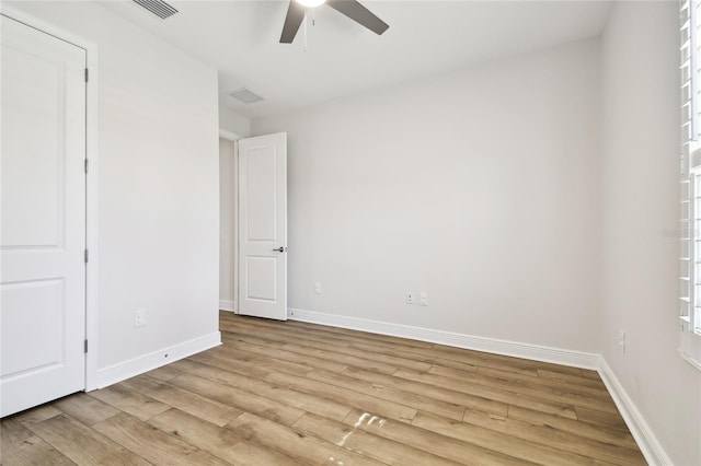 8766 Shadyside Ln, Land O Lakes, FL 34637 - unfurnished bedroom featuring light wood-style floors, baseboards, and ceiling fan