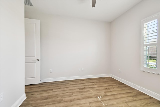 8766 Shadyside Ln, Land O Lakes, FL 34637 - spare room with wood finished floors, healthy amount of natural light, ceiling fan, and baseboards