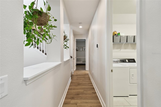 8766 Shadyside Ln, Land O Lakes, FL 34637 - corridor with radiator heating unit, independent washer and dryer, baseboards, light wood-style floors, and recessed lighting
