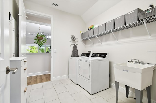 8766 Shadyside Ln, Land O Lakes, FL 34637 - laundry room featuring separate washer and dryer and baseboards